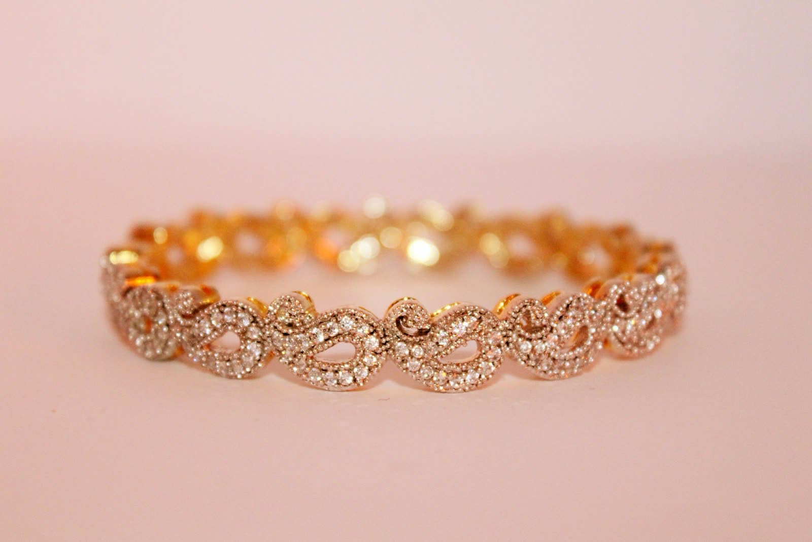 Gold-tone chain necklace worn at the collarbone